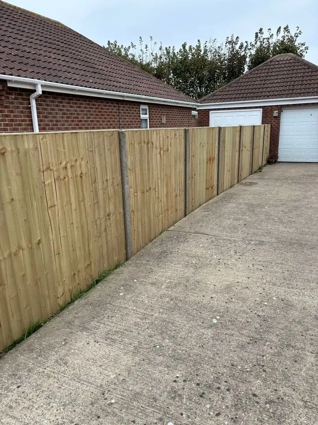 Closeboard fence beside a driveway