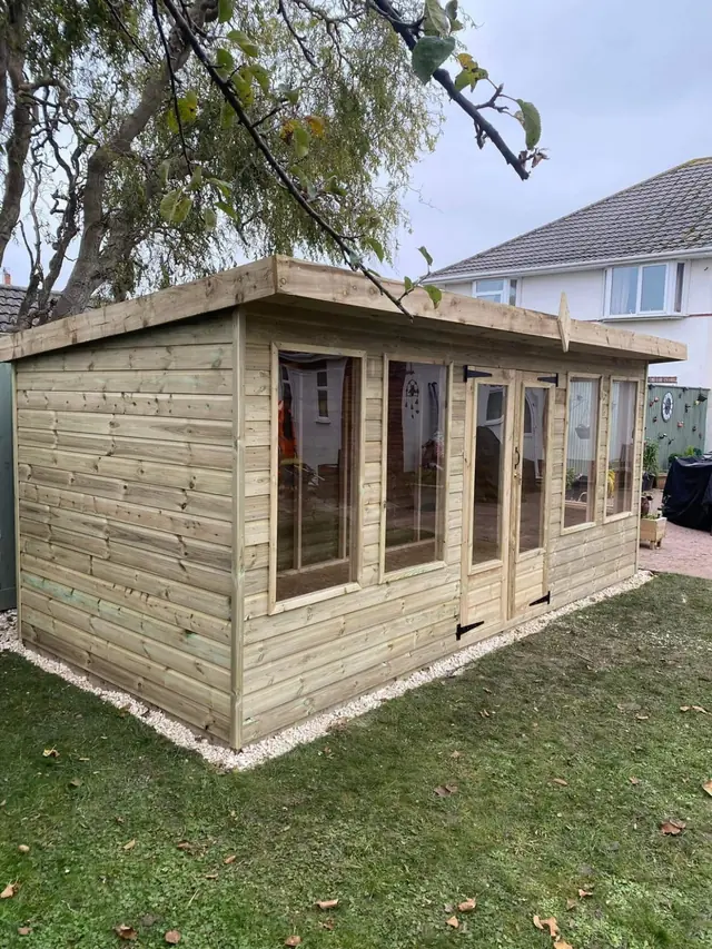 Timber summerhouse with full-height windows